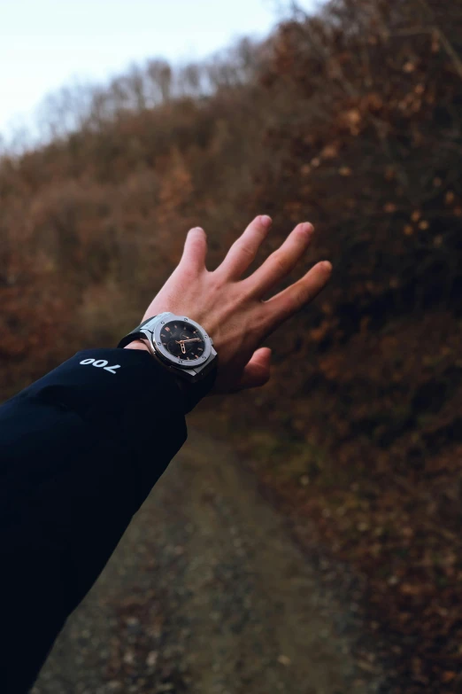 a man's hand is reaching for a stopwatch