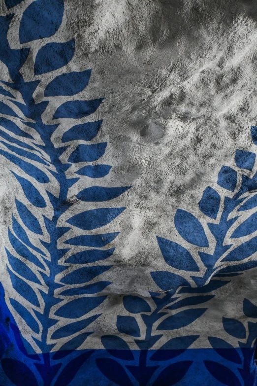 abstractly painted leaf design on fabric in black, white and blue colors