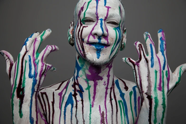 a person with colored paint painted all over their body