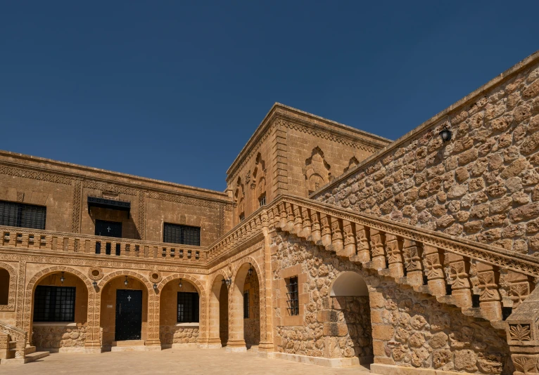 the exterior of an old building, with a courtyard and columns