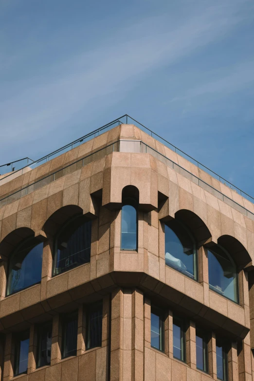 an elegant building with lots of windows and a blue sky