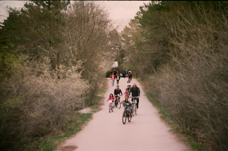 group of bicyclist walking up trail together