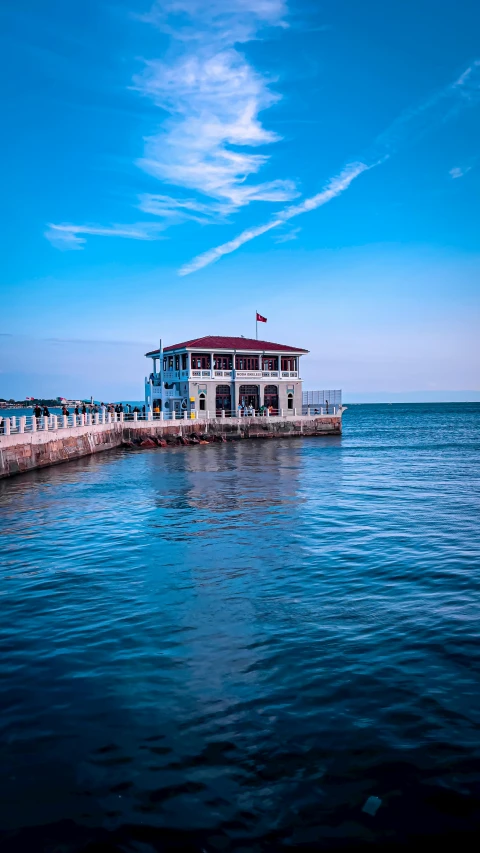 the pier has a large blue boat with a roof