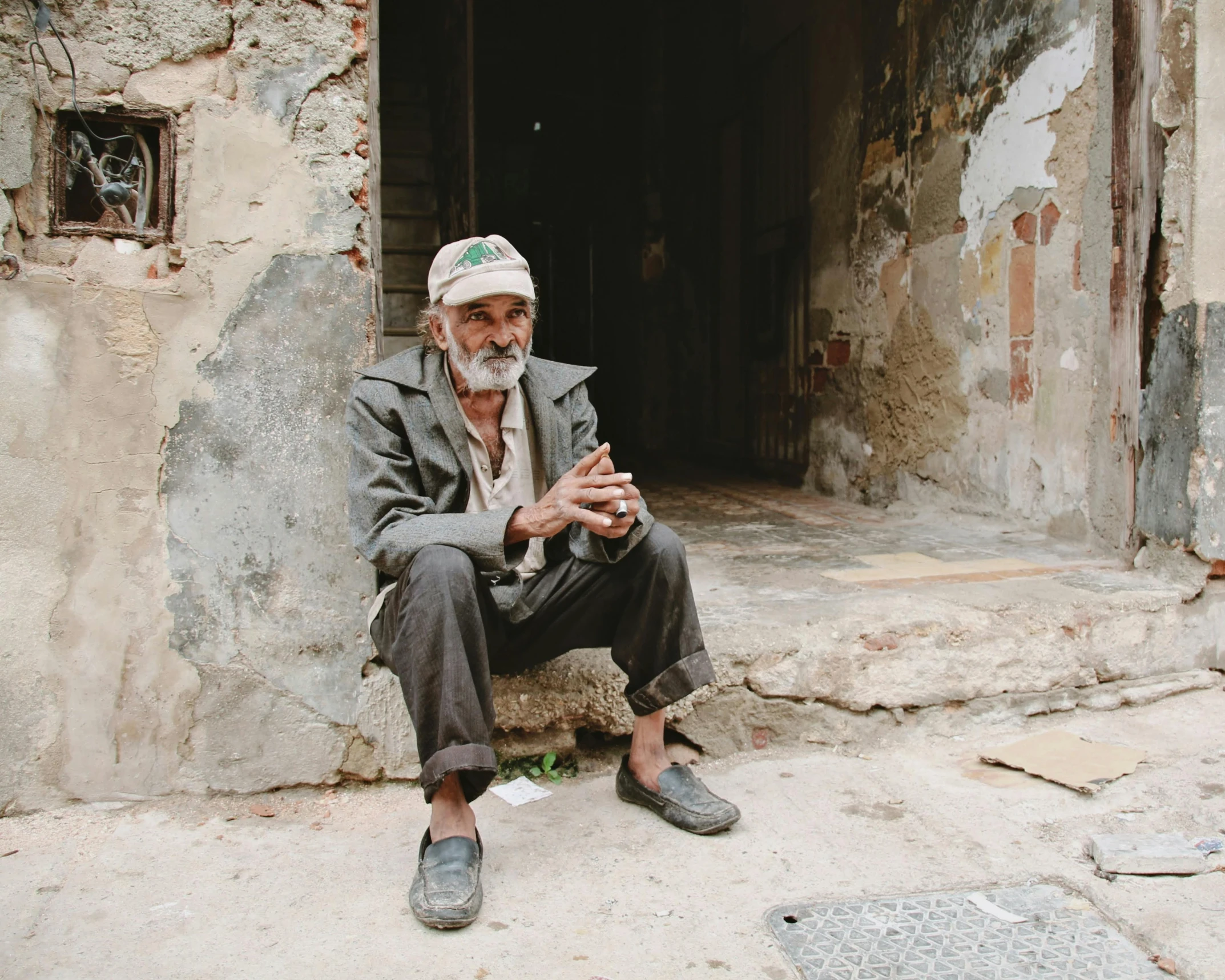 an old man sitting on some steps