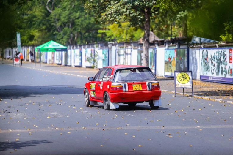 a red car is parked on the side of the road