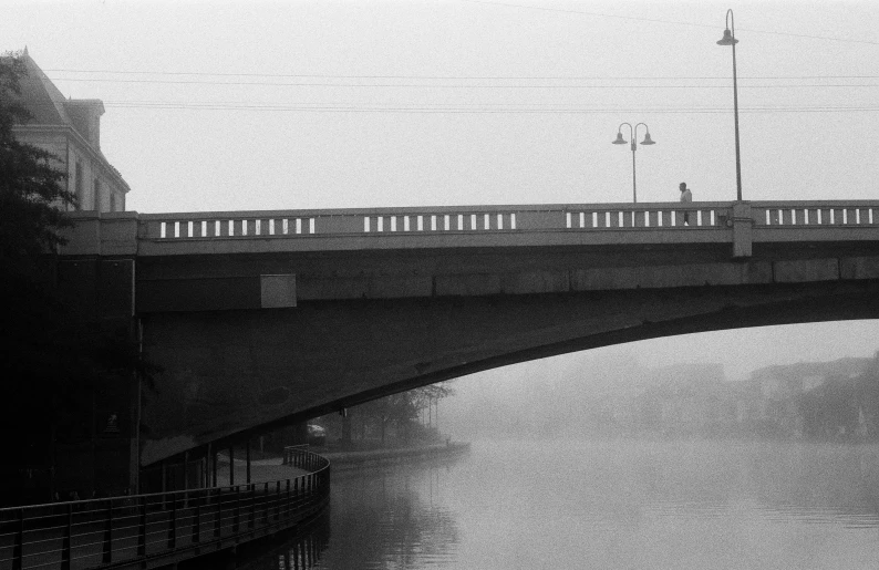 a large bridge crossing over a river next to tall buildings