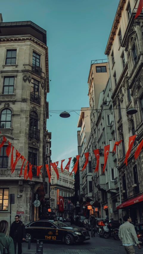 an image of a busy city street with banners hanging on it's buildings