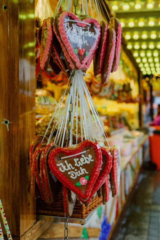 valentine's day ornaments hanging from wooden racks in a shop