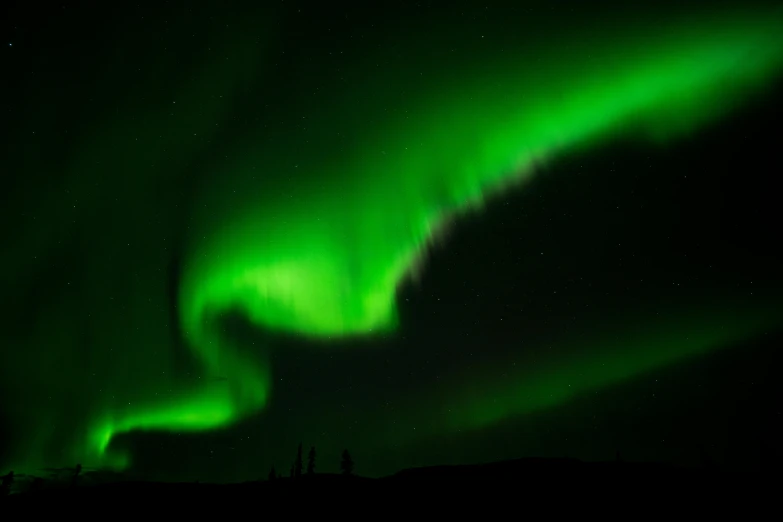 the aurora boreds as it is illuminated over the arctic tundra