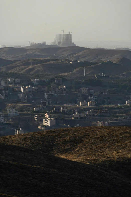 view from a hill showing an area of houses on the other side