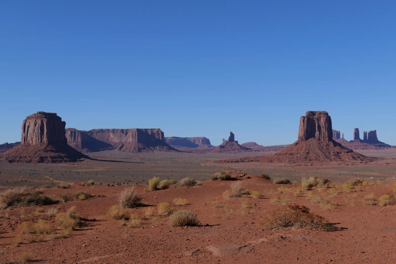 a red dirt field that has very little vegetation in it