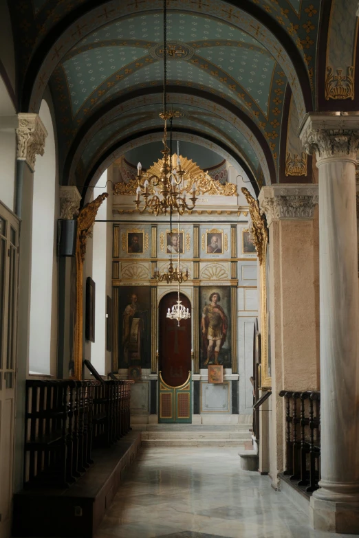 a room with high ceilings and chandelier hanging from the ceiling