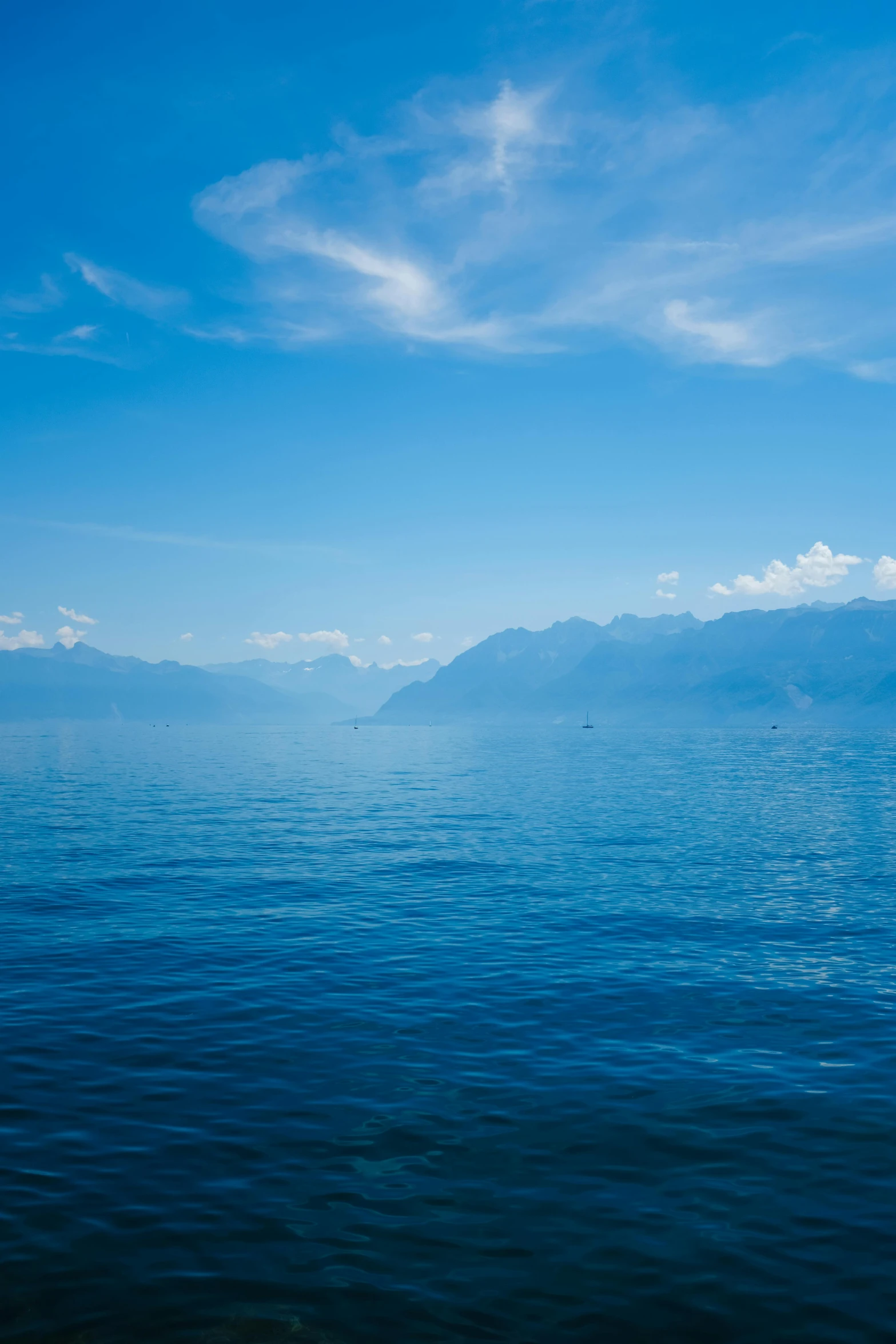 the view of an empty, calm lake from a distance