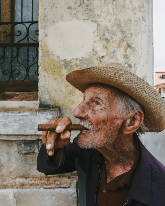 man in a hat smoking a cigarette