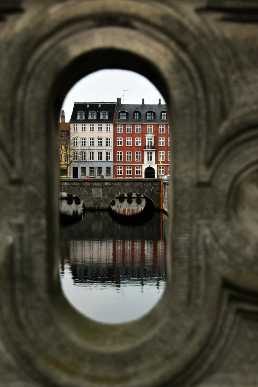 a reflection of a city in water with buildings