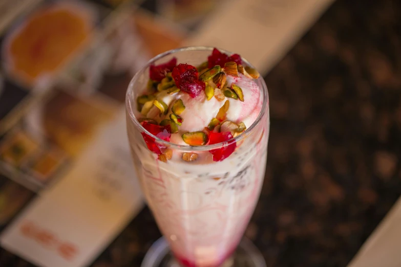 a glass of drink with fruit on the bottom