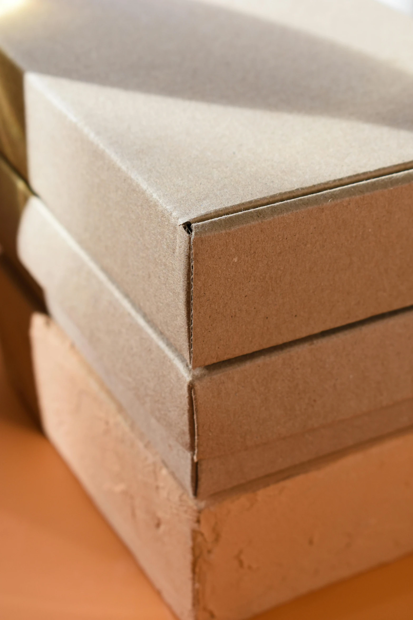 three cardboard boxes with metal handles on a table