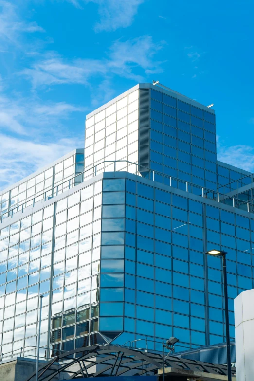 an abstract glass building sits next to traffic lights