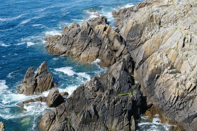 an aerial view of rocks next to the water