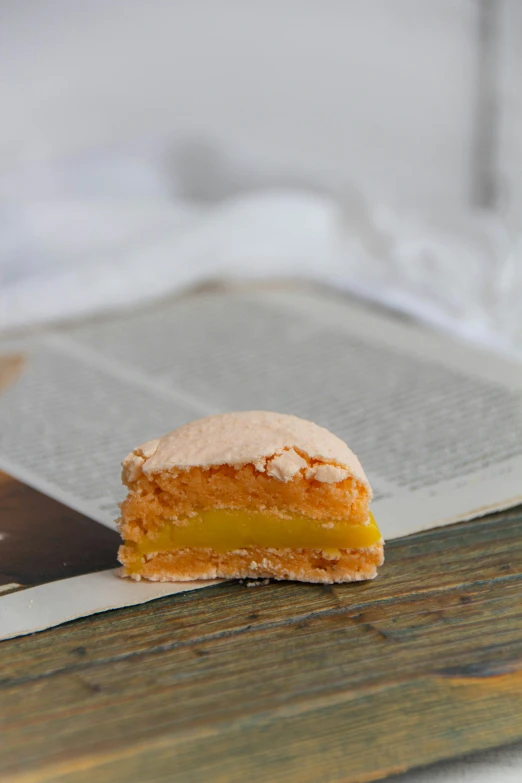 a piece of pie sits on the edge of a wooden table