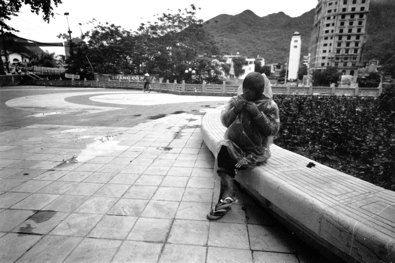 a person sitting on a bench at the park looking back