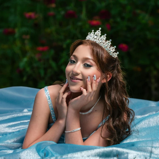 an attractive young woman wearing a tiara posing for the camera