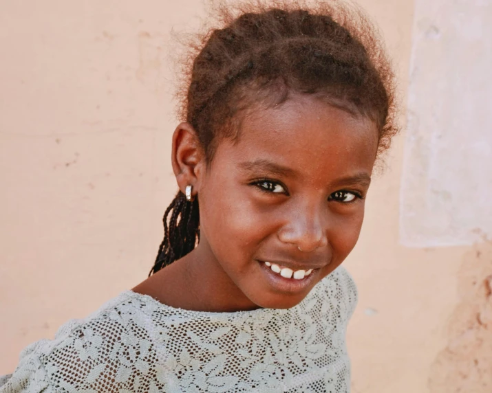 an adorable little girl smiling for the camera