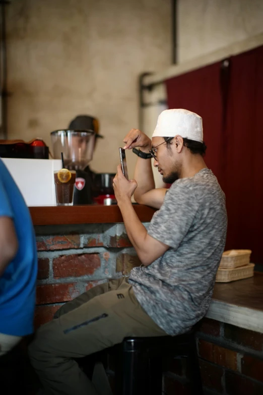 a man sitting on top of a table with food