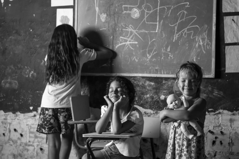 two s in their classroom sitting on a desk