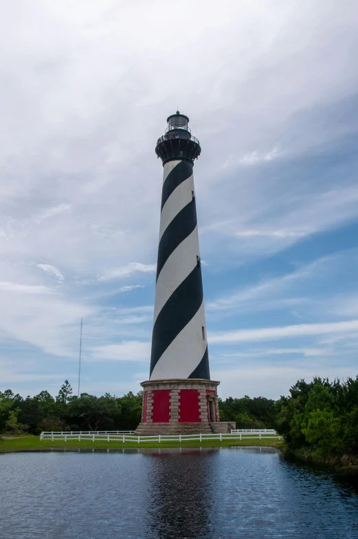 a large light house sitting on top of a river