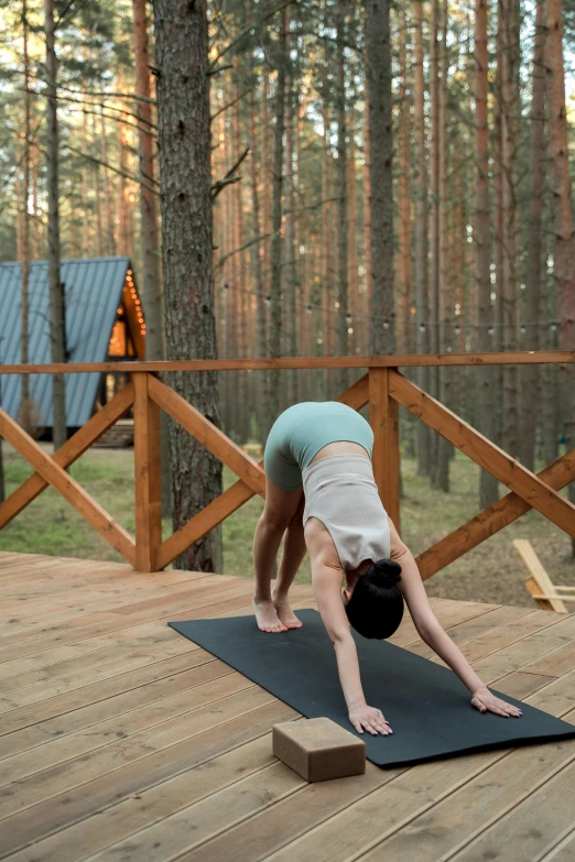 woman doing handstand in a forest with blue skies