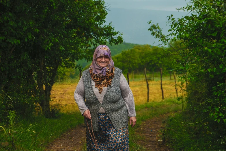 a woman in a park is smiling on the trail