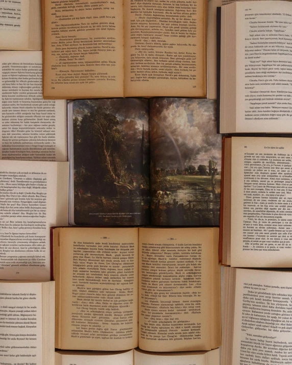 a stack of open books sitting next to each other