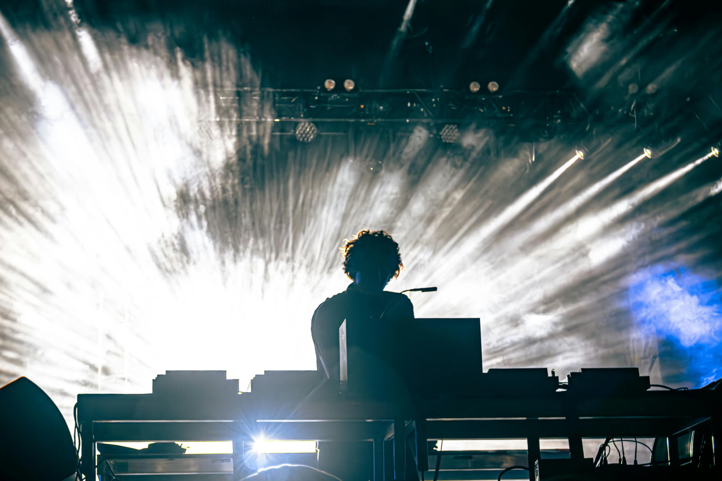 a person playing the keyboards on stage during a concert