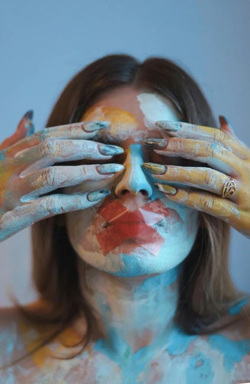 a woman with her hands painted and covered in yellow