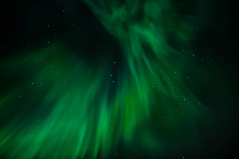 an aurora bore in the night sky with stars and green color