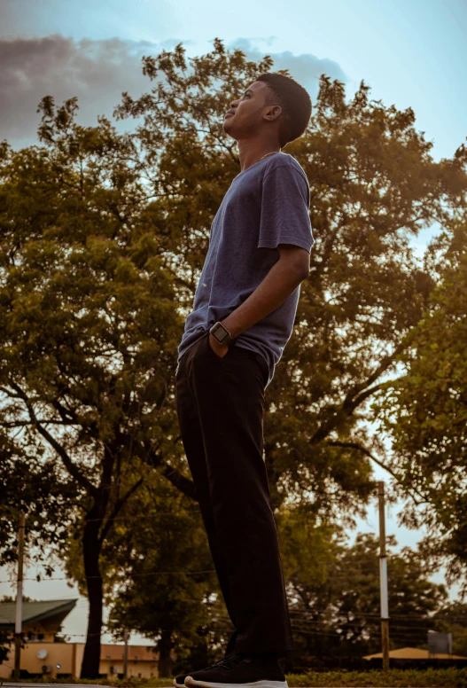 a boy is riding a skateboard in front of trees