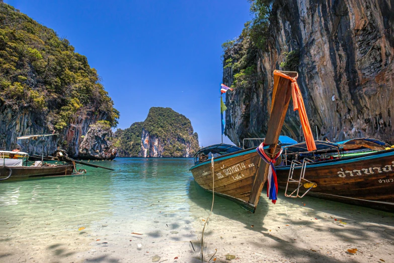 several boats docked next to each other on the beach