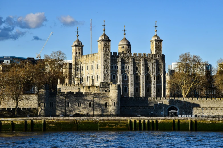 a large castle next to a body of water