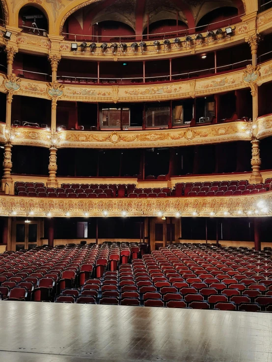 a long empty auditorium filled with lots of chairs