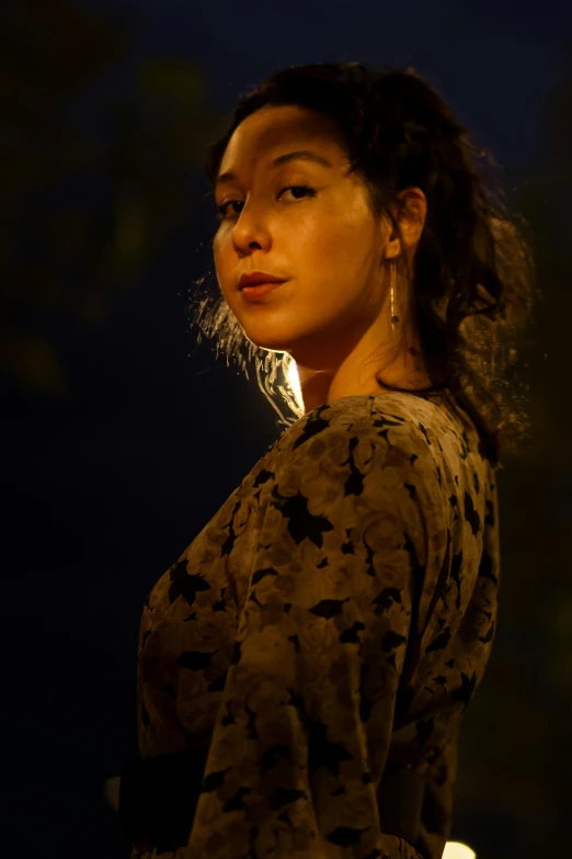 a woman in a black shirt is wearing large earrings