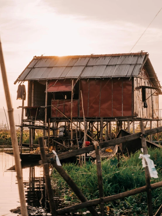 there is a hut built on the water's edge