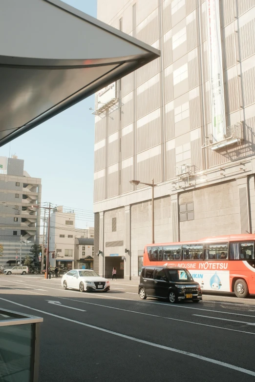 two city busses sit on the side of the road