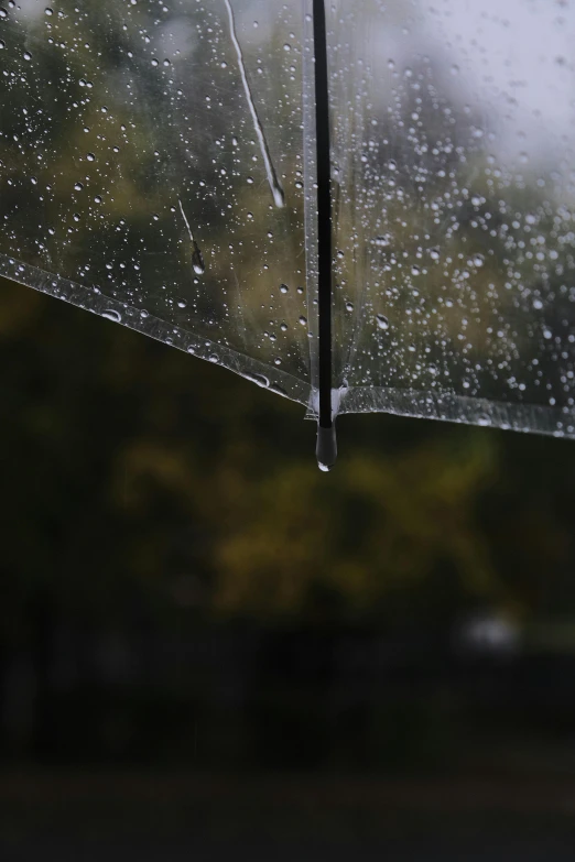 an umbrella with rain drops on it outside