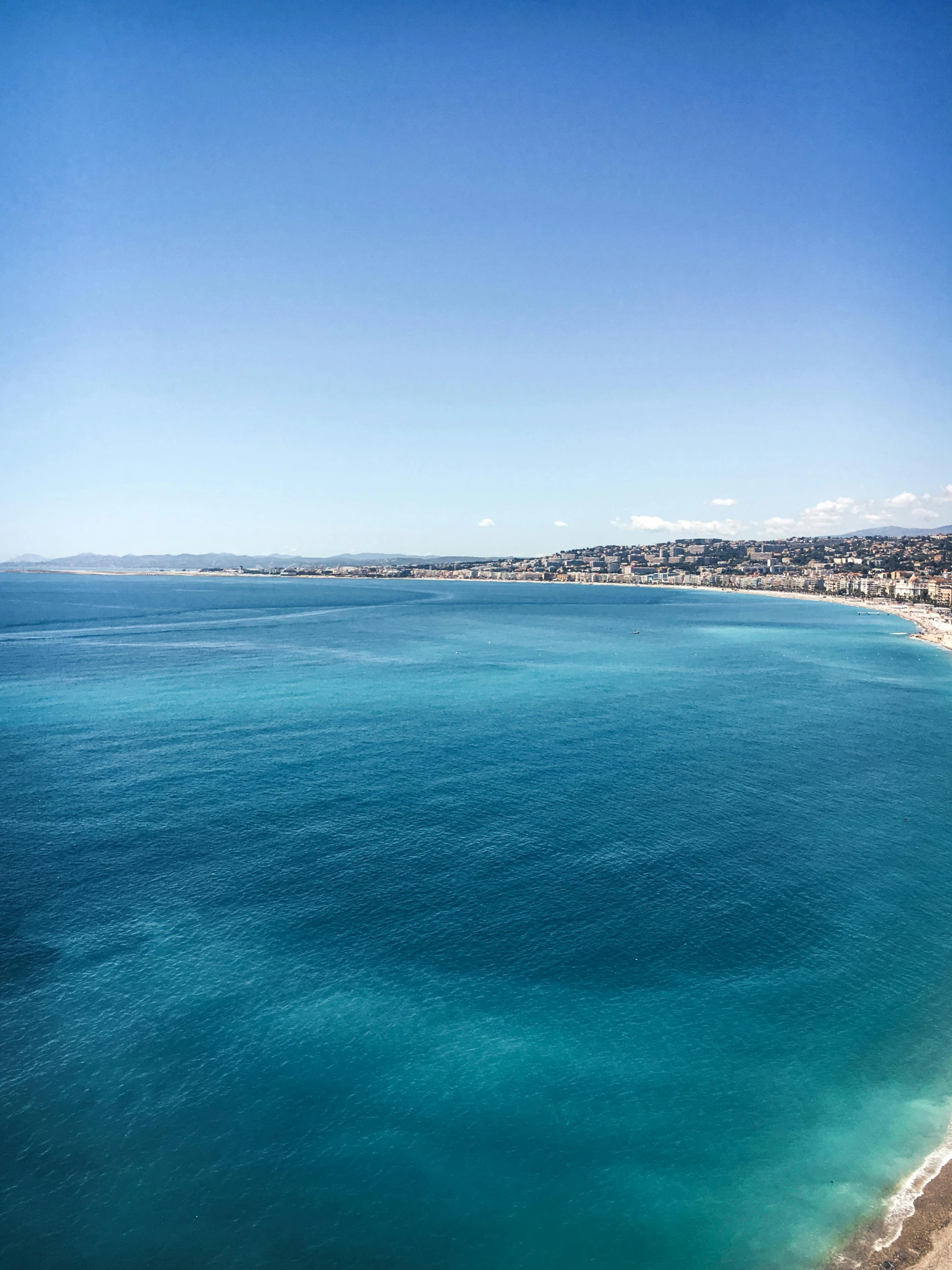 a view of a beach and city in the background