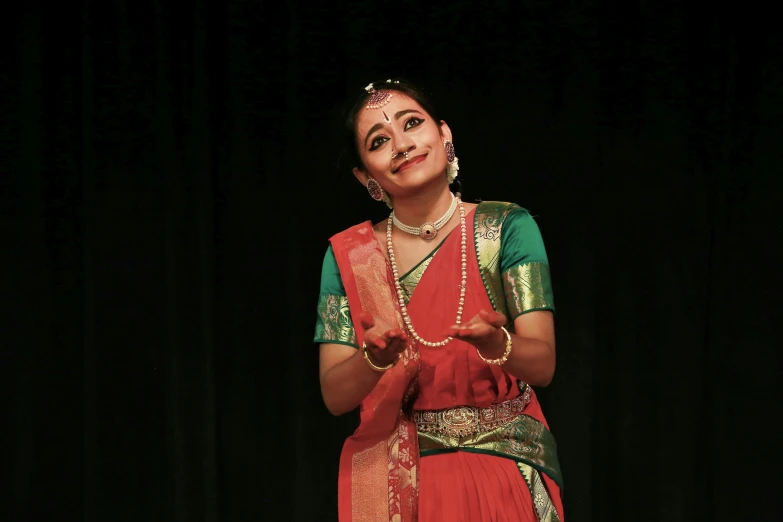 a young woman in traditional attire holding soing