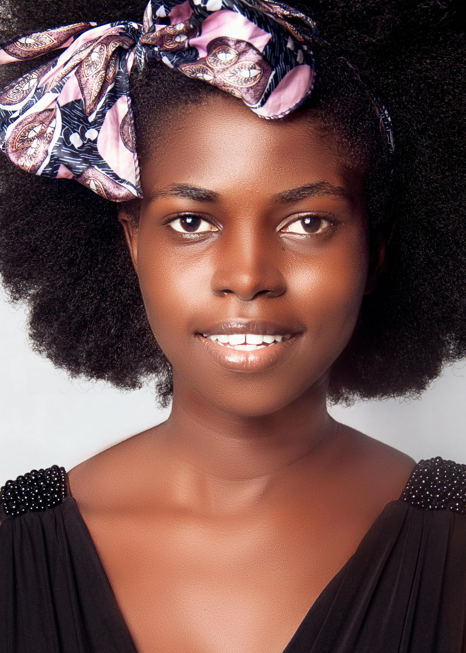 an african american woman wearing a bow on her head