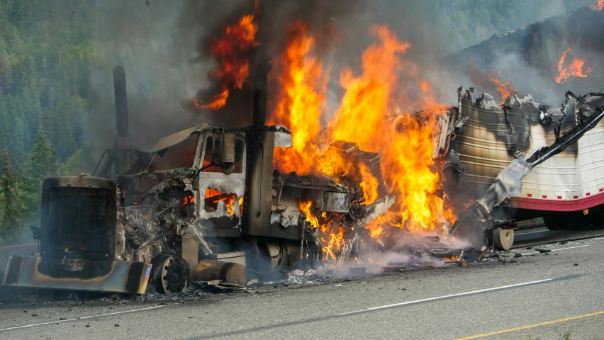 a large truck has been burnt and on fire