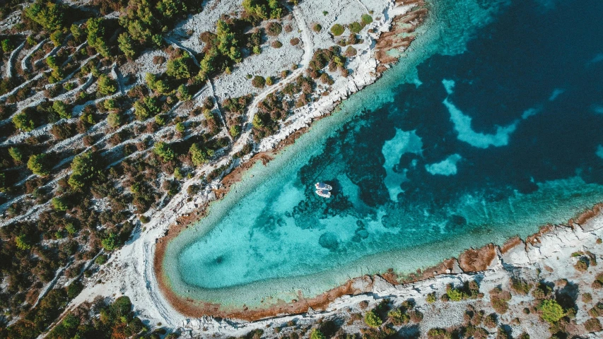 two people on a boat in a blue body of water