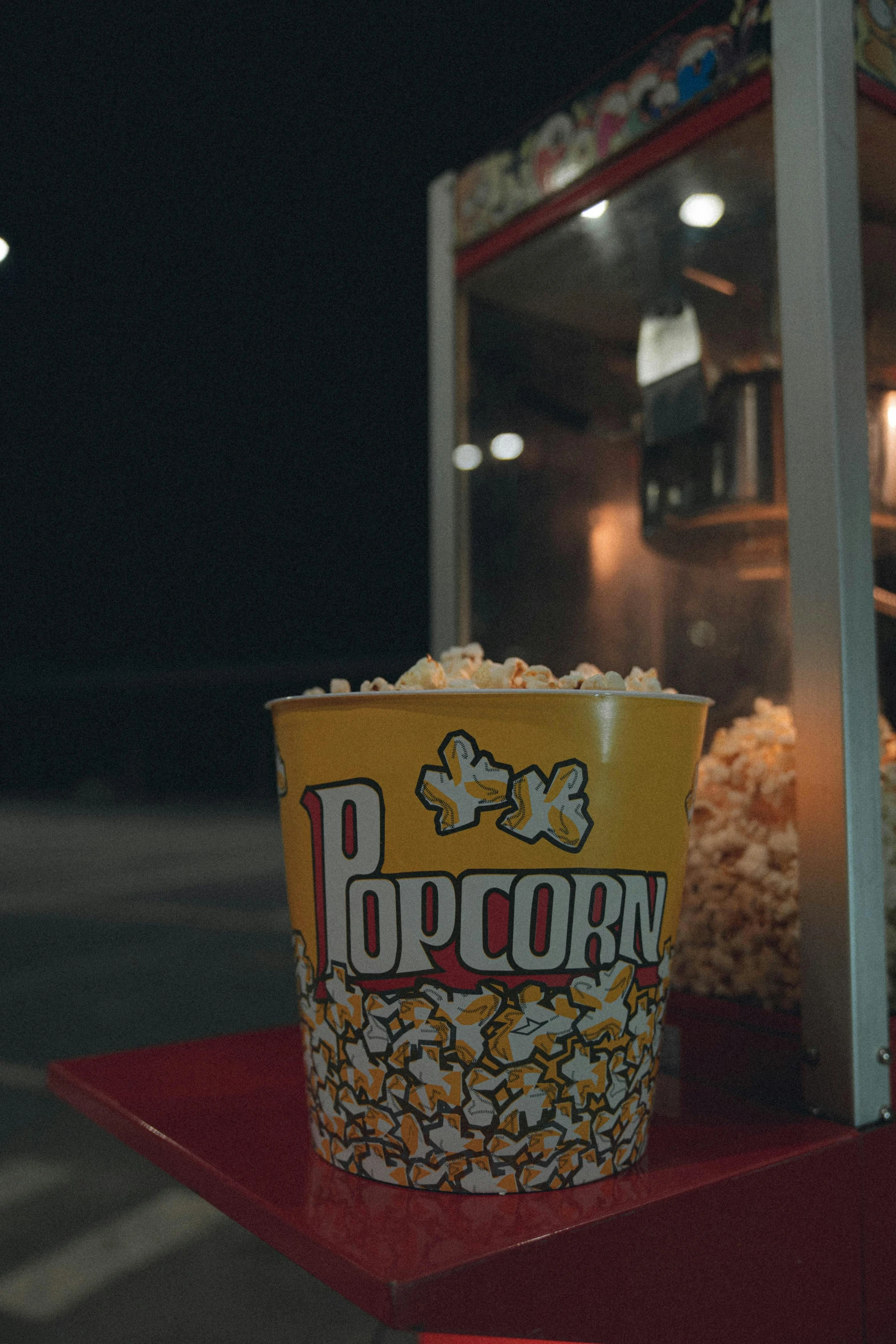 a bucket of popcorn sitting on top of a table